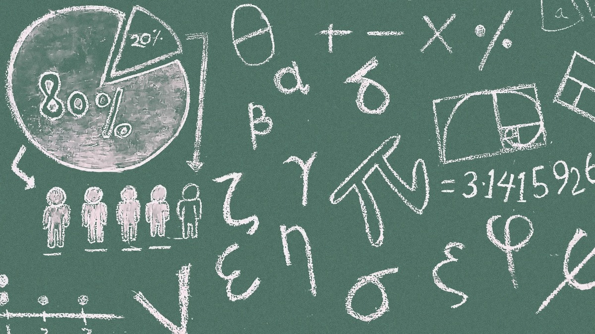 Math symbols and equations written in chalk on a chalkboard.